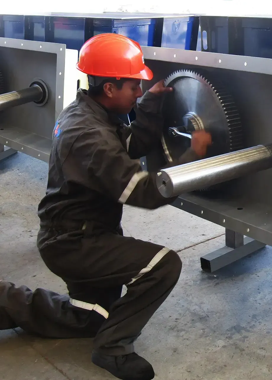 TRIASO employee adjusting a gear